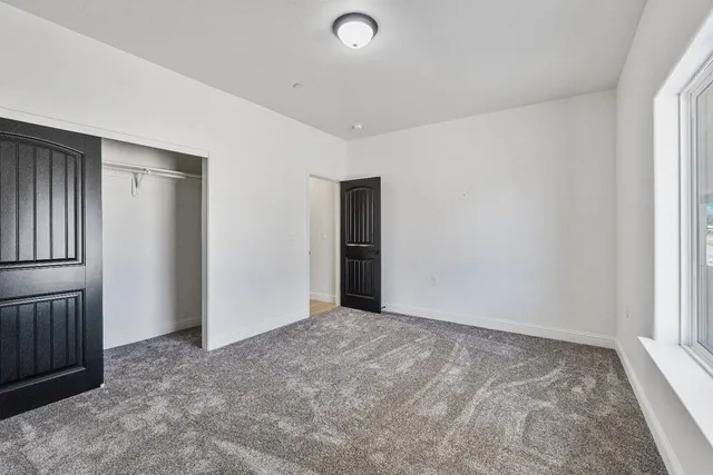a bathroom with a double vanity sink toilet mirror and shower