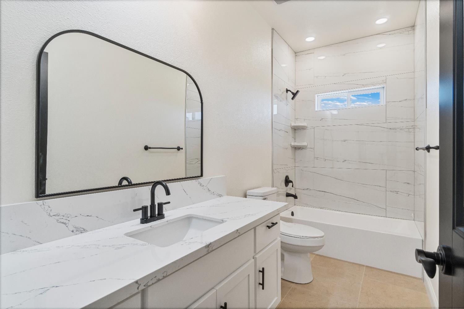 21035 Forest Glen Road Madera, CA 93638 - Photo 24 of 31 a bathroom with a double vanity sink toilet mirror and shower