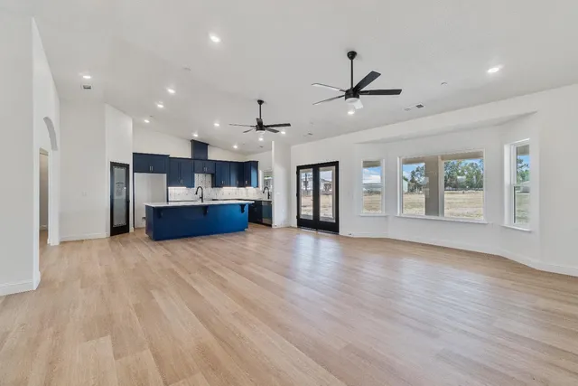 a view of kitchen and hall with wooden floor
