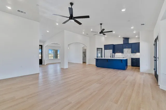 a kitchen with wooden floors and wooden cabinets