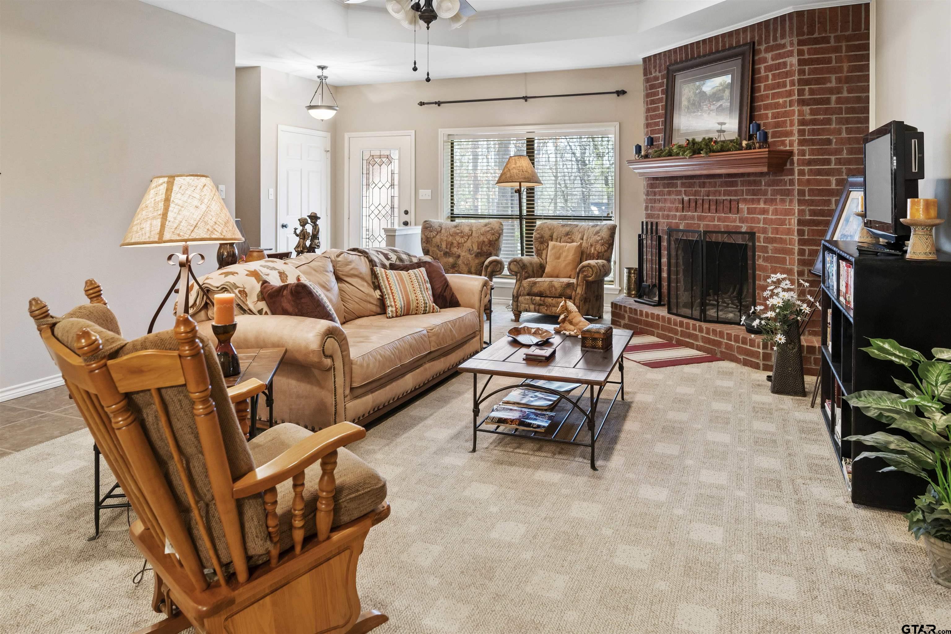 175 Old Gate Path Holly Lake Ranch, TX 75755 - Photo 5 of 28 a living room with furniture a fireplace and a table