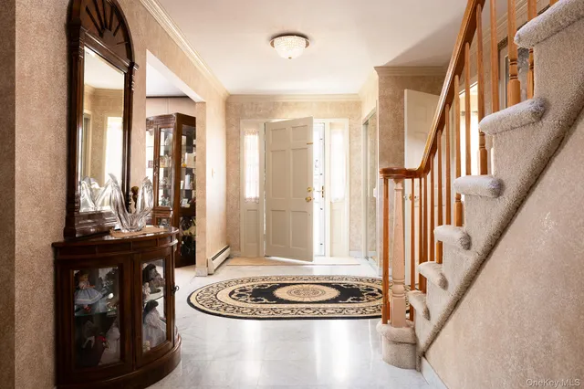 a view of a livingroom with furniture and staircase