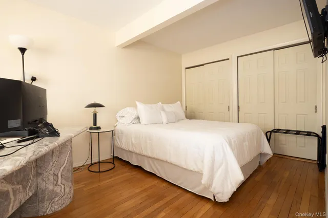 a bedroom with a bed and a flat screen tv