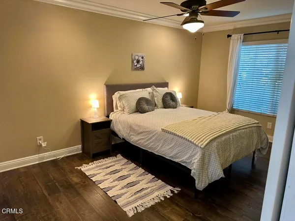 a bedroom with a bed and a ceiling fan