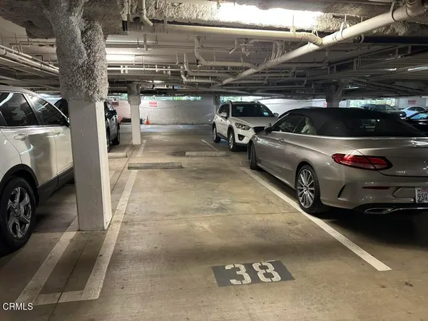 a view of patio with table and chairs under an umbrella