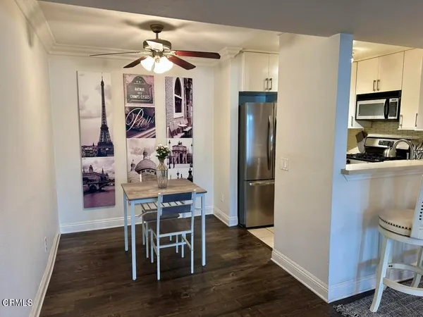 a living room with furniture and large windows