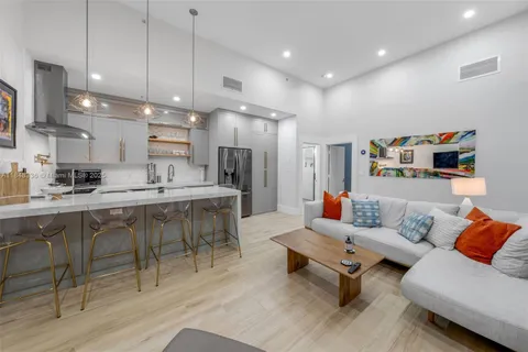 a kitchen with stainless steel appliances a refrigerator and a stove top oven