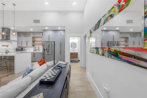 a kitchen with kitchen island a refrigerator a sink and a stove top oven