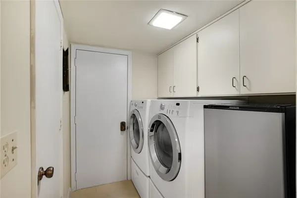 a living room with large windows and a table
