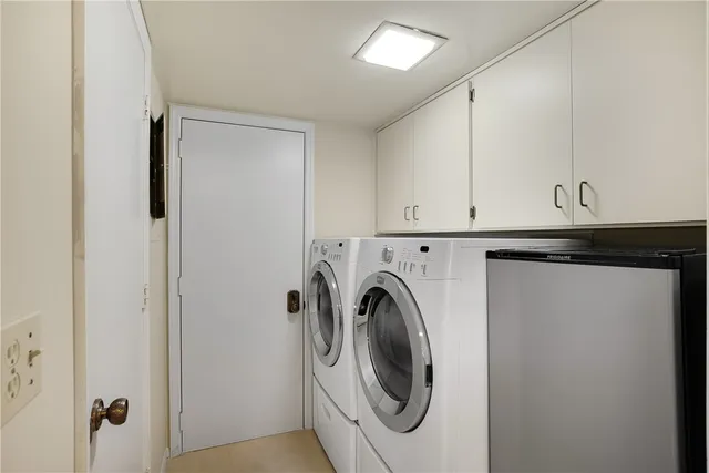 a living room with large windows and a table