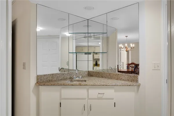 a kitchen with granite countertop a sink stainless steel appliances and cabinets