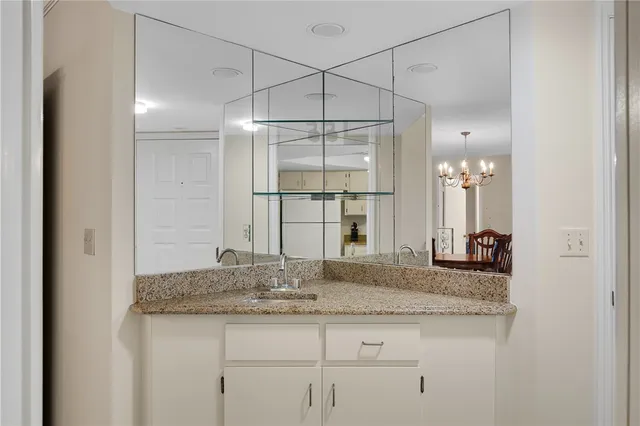 a kitchen with granite countertop a sink stainless steel appliances and cabinets