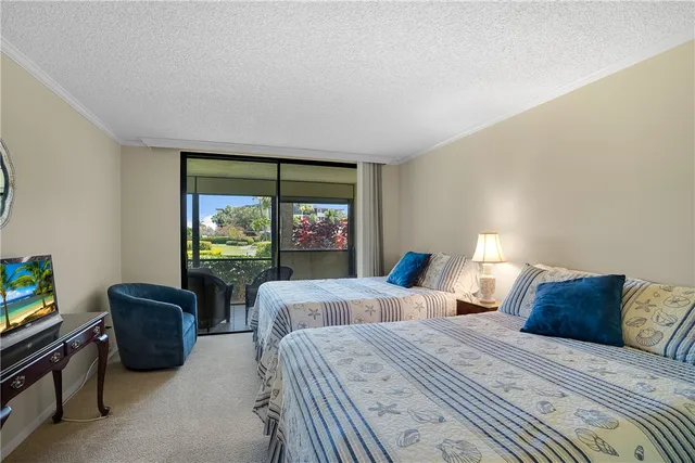 a bedroom with two beds and a large window