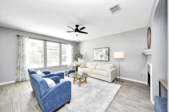 a living room with furniture and a large window