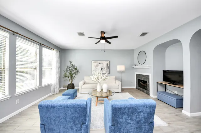 a living room with fireplace furniture and a flat screen tv