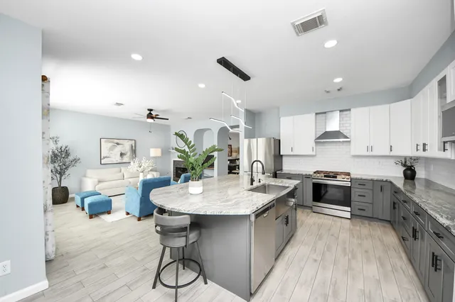 a large kitchen with kitchen island a sink counter space and stainless steel appliances