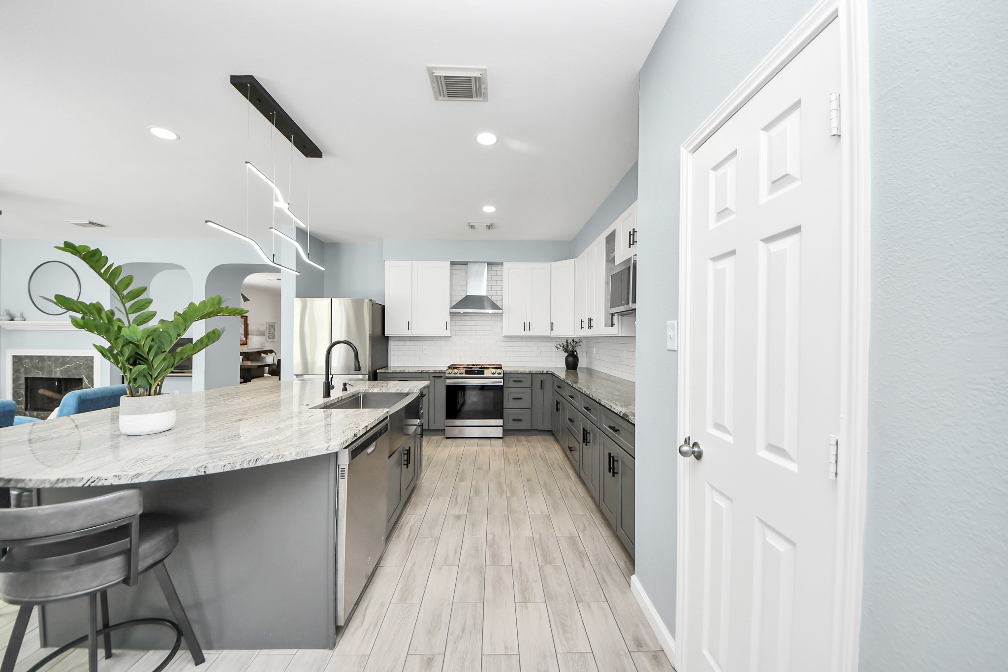 7619 Park Sage Lane Cypress, TX 77433 - Photo 22 of 48 a kitchen with stainless steel appliances granite countertop a refrigerator a sink dishwasher and white cabinets with wooden floor