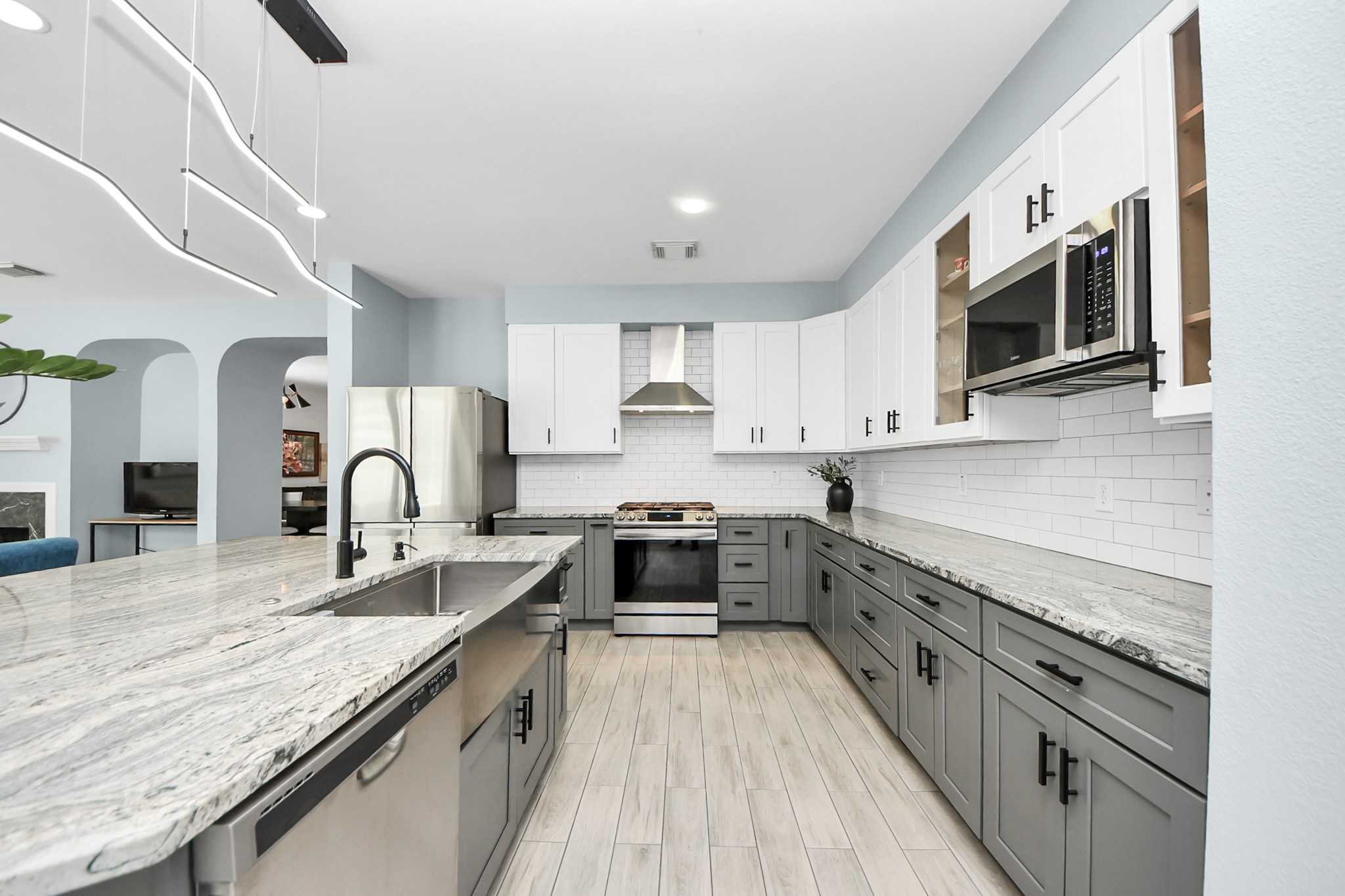 7619 Park Sage Lane Cypress, TX 77433 - Photo 23 of 48 a large kitchen with stainless steel appliances granite countertop a stove and a sink