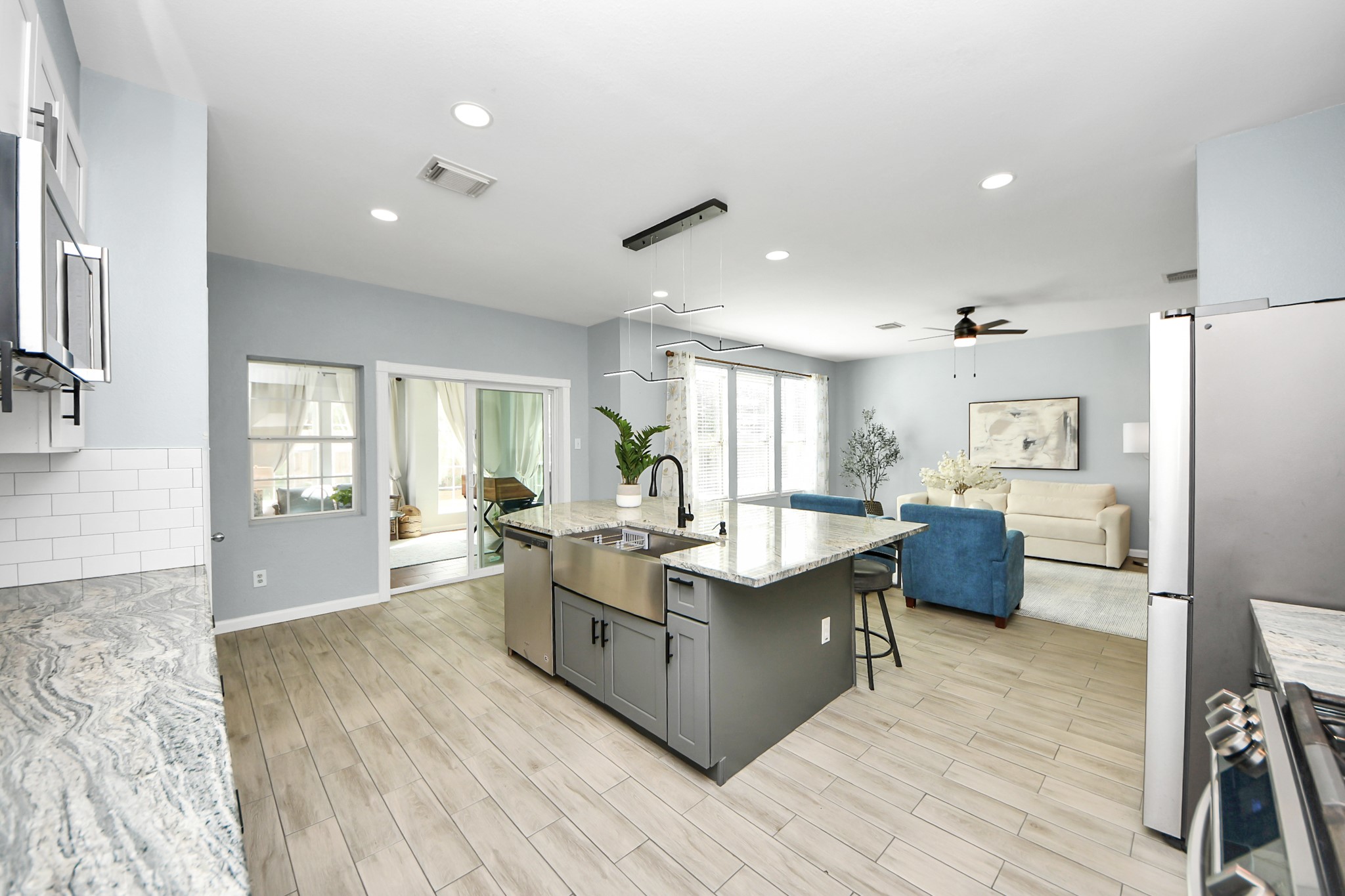 7619 Park Sage Lane Cypress, TX 77433 - Photo 25 of 48 a large living room with stainless steel appliances granite countertop a couch and wooden floor