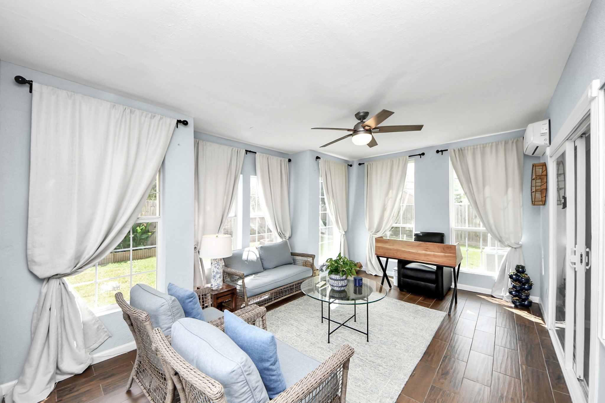 7619 Park Sage Lane Cypress, TX 77433 - Photo 28 of 48 a living room with furniture a large window and a wooden floor