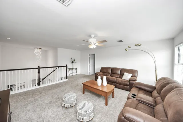 a living room with furniture and a chandelier