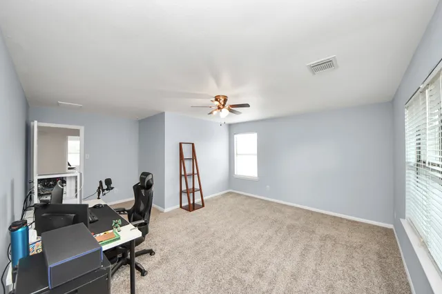 a work room with furniture and a window