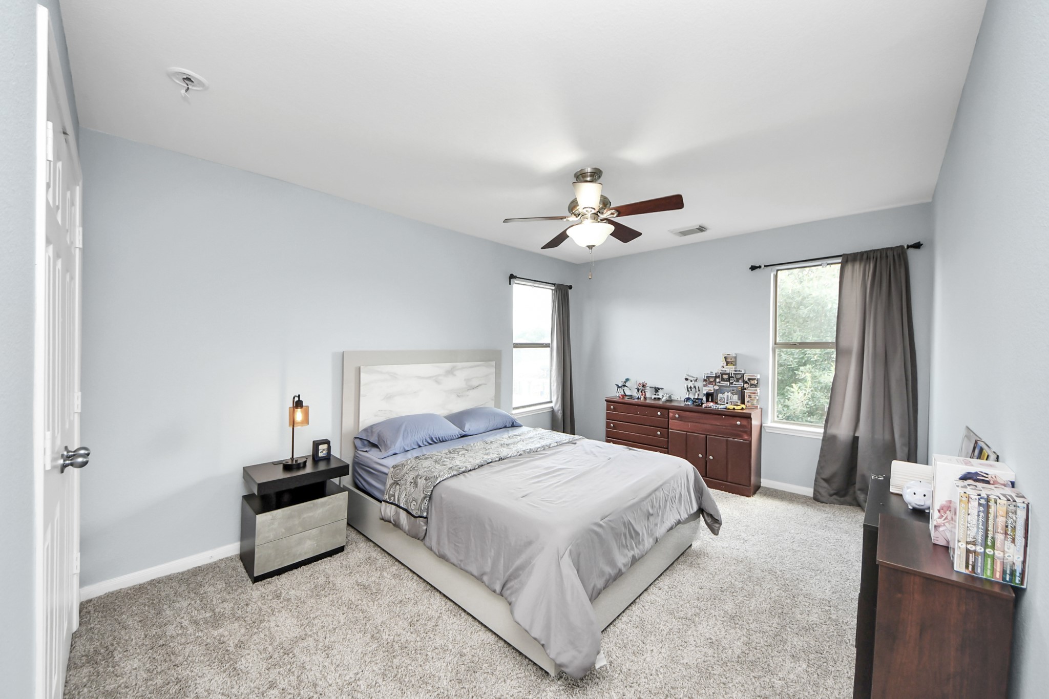 7619 Park Sage Lane Cypress, TX 77433 - Photo 43 of 48 a spacious bedroom with a bed and a chandelier