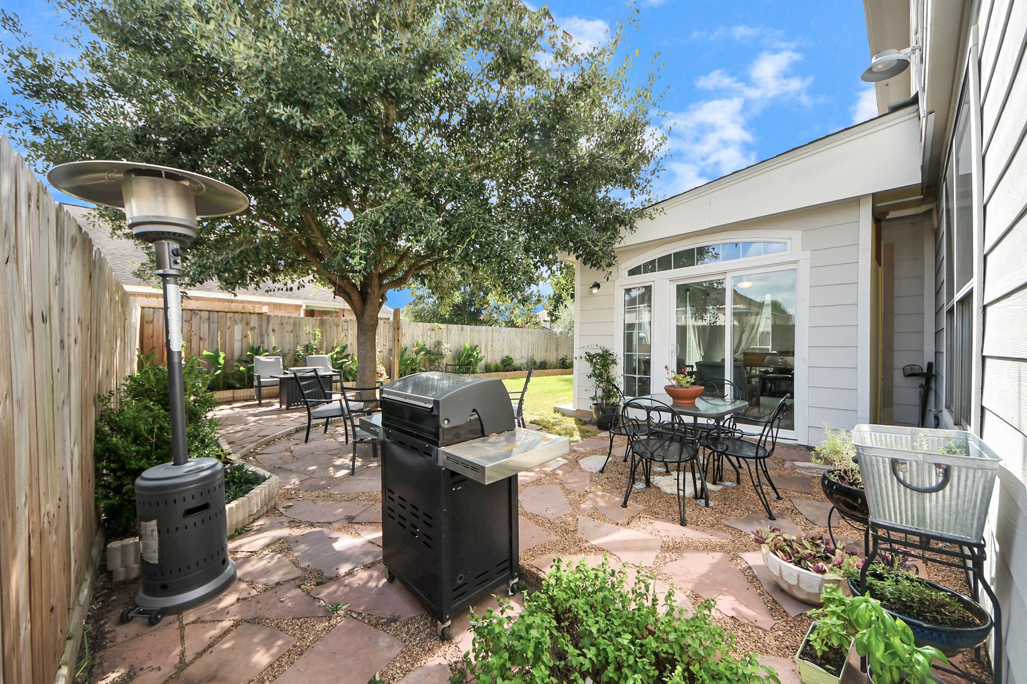 7619 Park Sage Lane Cypress, TX 77433 - Photo 45 of 48 a roof deck with table and chairs potted plants and large tree