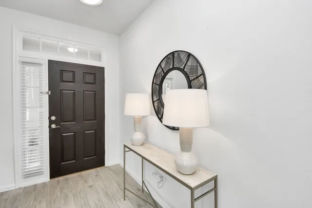 a bedroom with a bed and a mirror