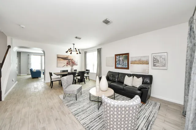 a living room with furniture and wooden floor