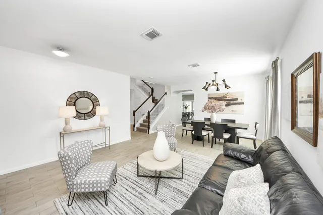 a living room with furniture and wooden floor