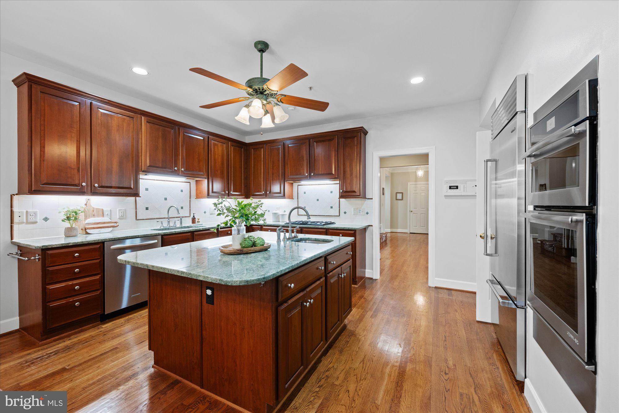 7822 Hidden Meadow Terrace Potomac, MD 20854 - Photo 11 of 29 a kitchen with stainless steel appliances granite countertop a sink stove and refrigerator