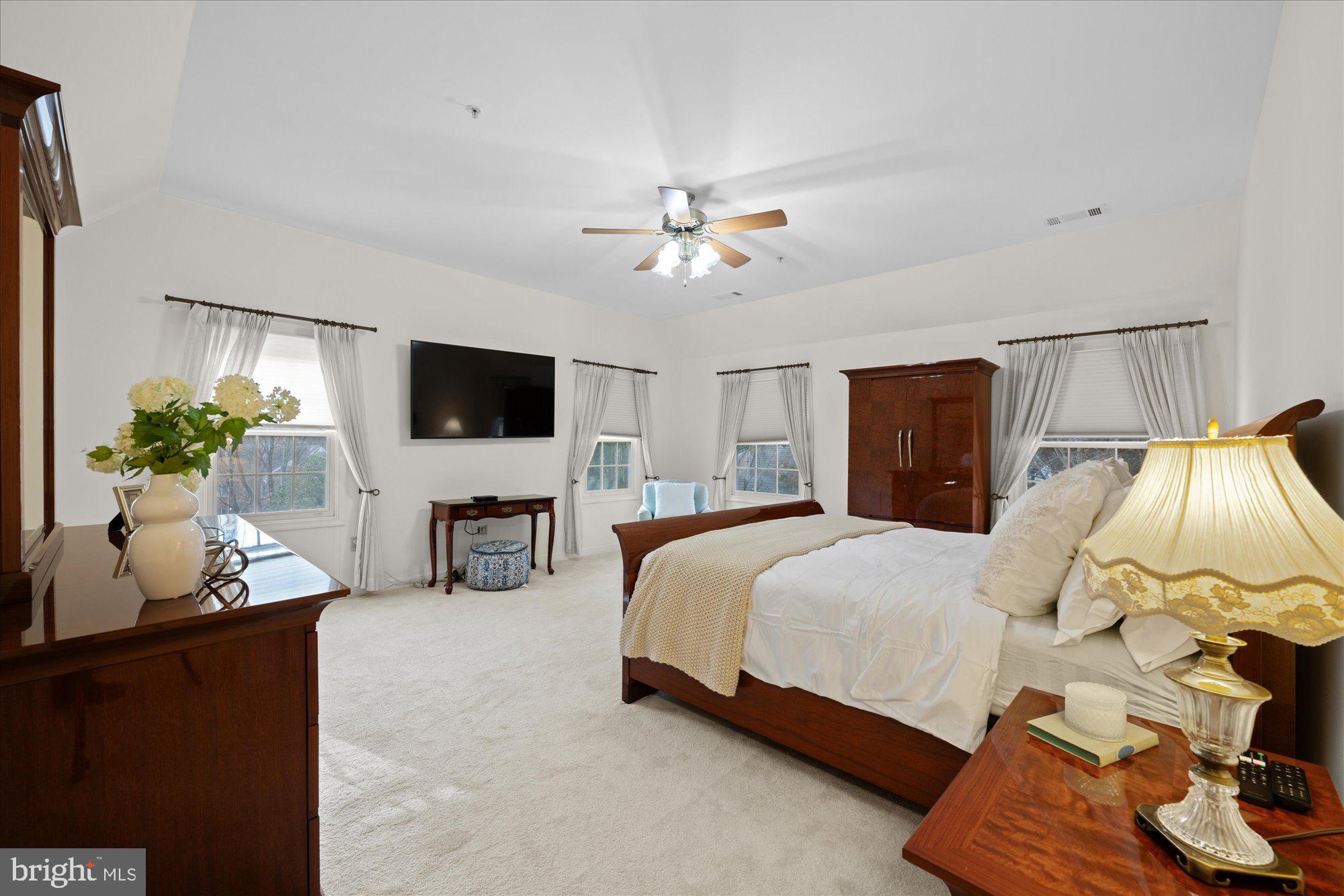 7822 Hidden Meadow Terrace Potomac, MD 20854 - Photo 17 of 29 a bed room with a bed window and a flat screen tv