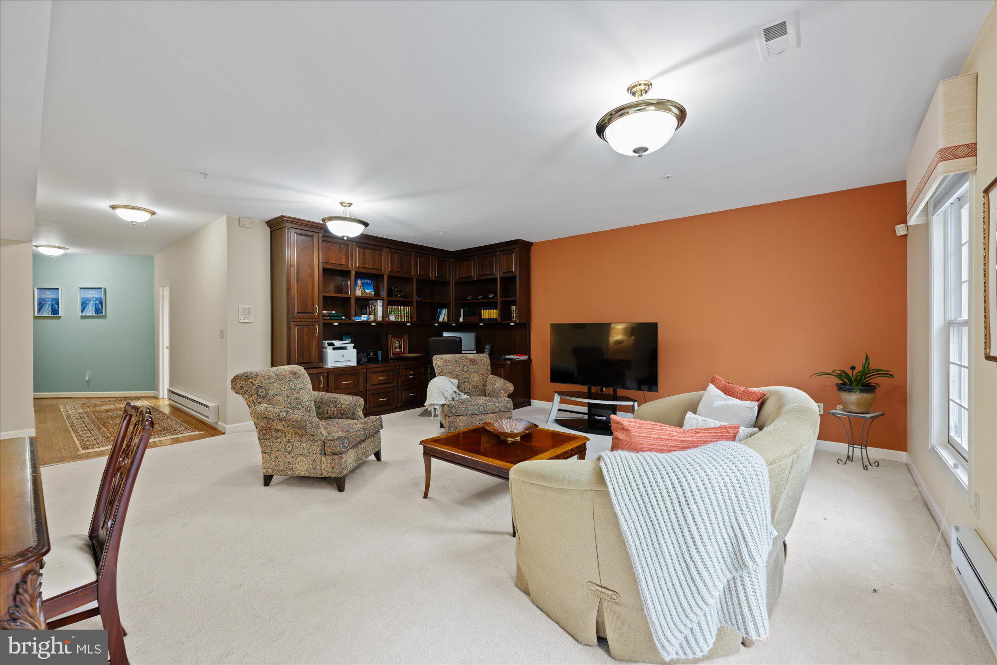 7822 Hidden Meadow Terrace Potomac, MD 20854 - Photo 25 of 29 a living room with furniture and a flat screen tv