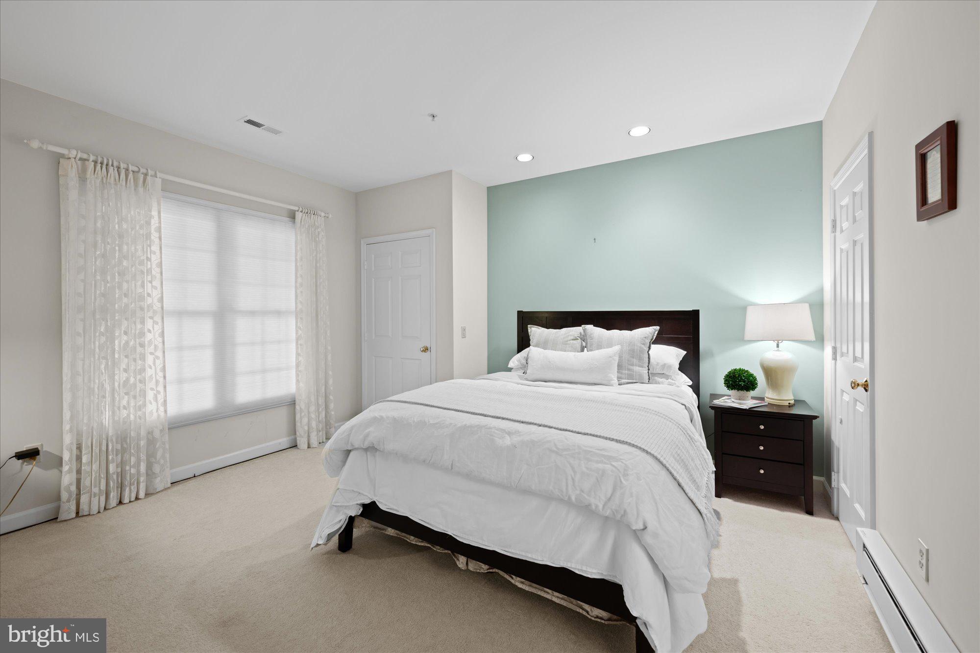 7822 Hidden Meadow Terrace Potomac, MD 20854 - Photo 26 of 29 a spacious bedroom with a bed and a window