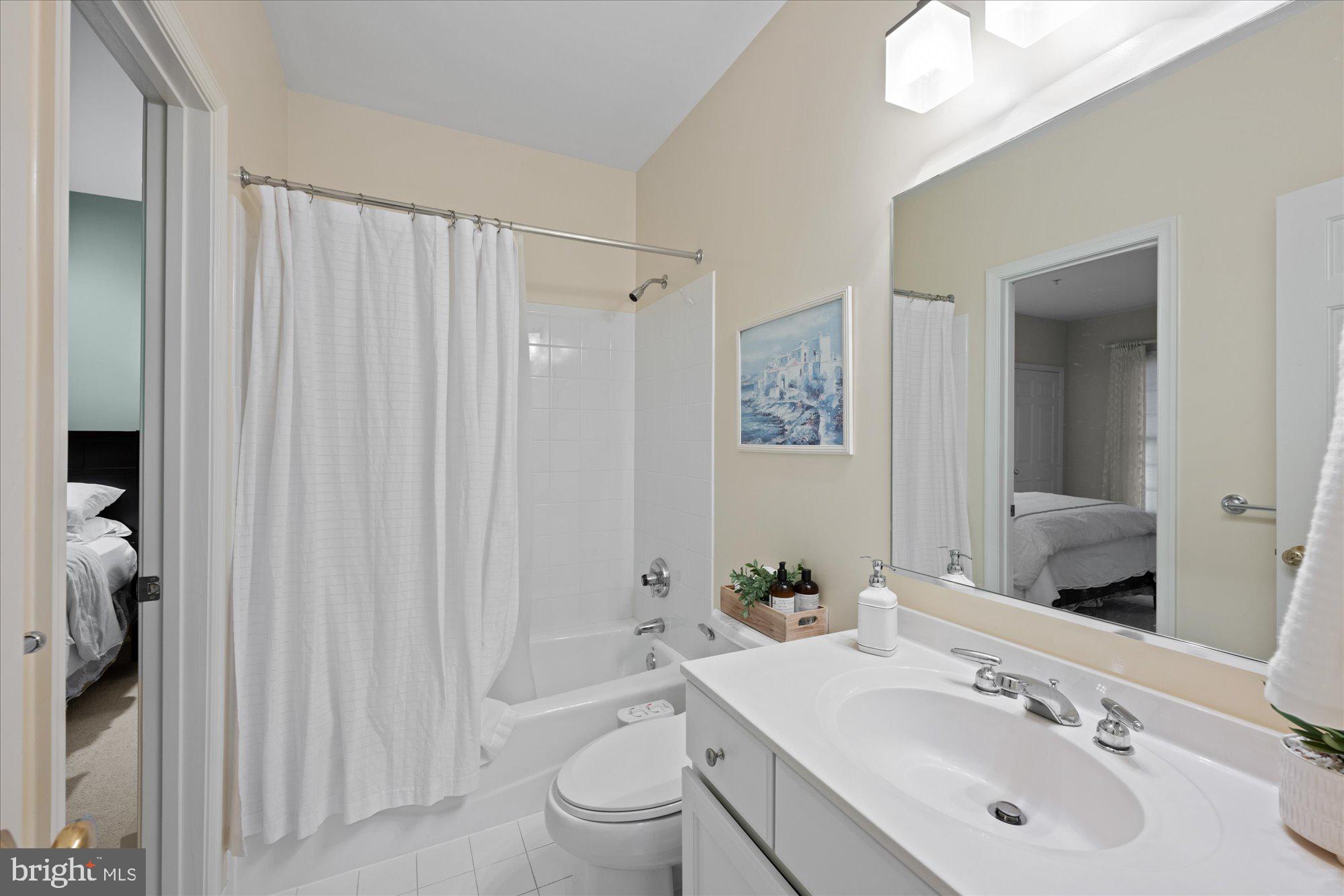 7822 Hidden Meadow Terrace Potomac, MD 20854 - Photo 27 of 29 a bathroom with a sink toilet and shower