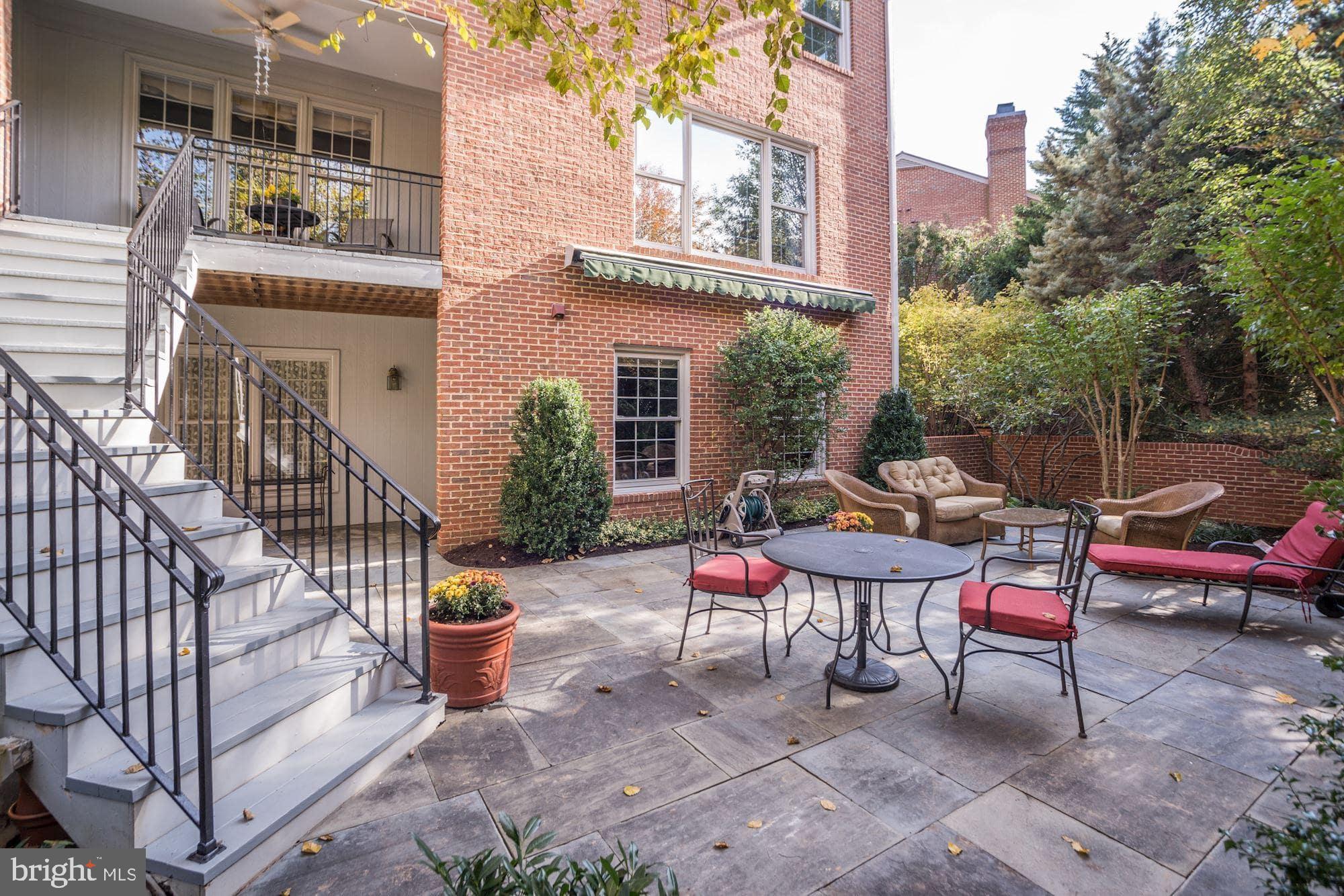 7822 Hidden Meadow Terrace Potomac, MD 20854 - Photo 4 of 29 a backyard of a house with barbeque oven table and chairs