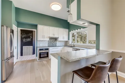 a kitchen with granite countertop a sink and a window
