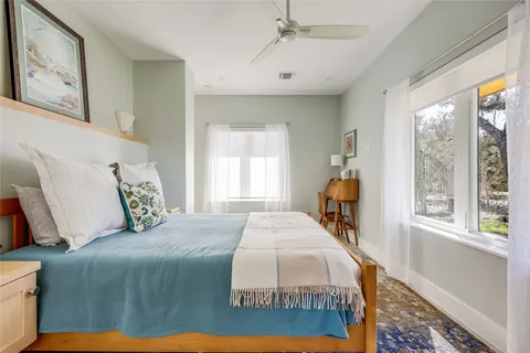 a spacious bathroom with a shower sink mirror and toilet
