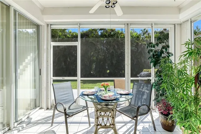 a balcony with furniture and potted plants