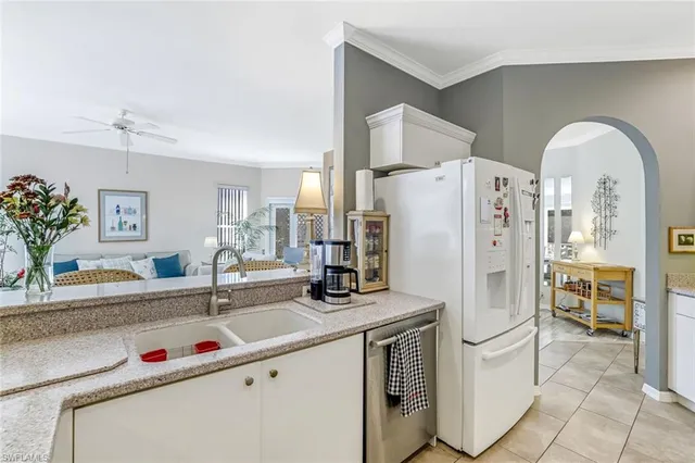 a kitchen with stainless steel appliances a sink stove and a refrigerator