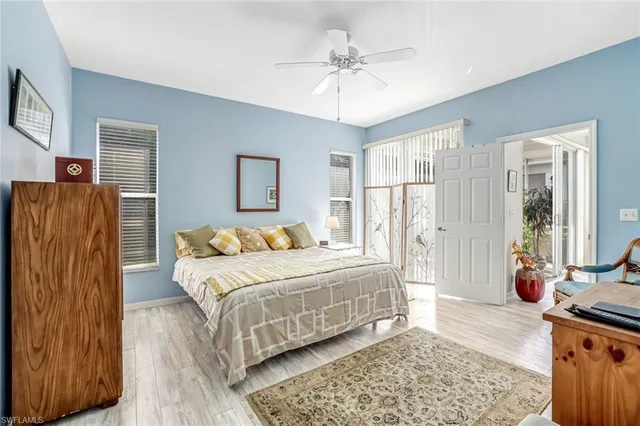 a bedroom with a bed a couch and dresser