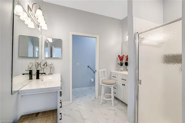 a bathroom with a sink mirror and a shower