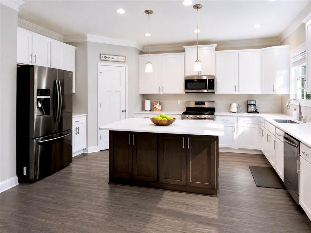 3359 Elkhorn Ridge Run Dacula, GA 30019 - Photo 10 of 35 a kitchen with a refrigerator a microwave and sink