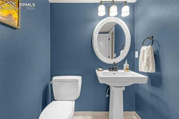 a bathroom with a granite countertop tub a sink and a large mirror