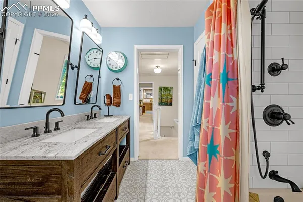 a bathroom with a sink a mirror and shower