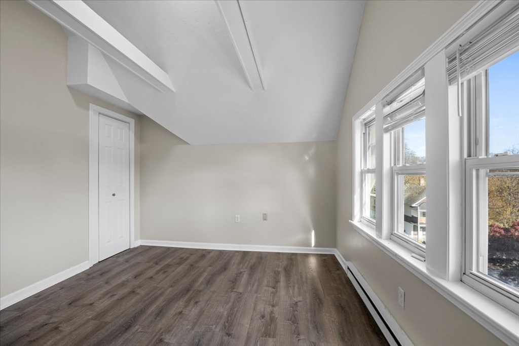 15 Clearview Avenue, Unit 3 Worcester, MA 01605 - Photo 12 of 24 a view of an empty room with wooden floor and a window