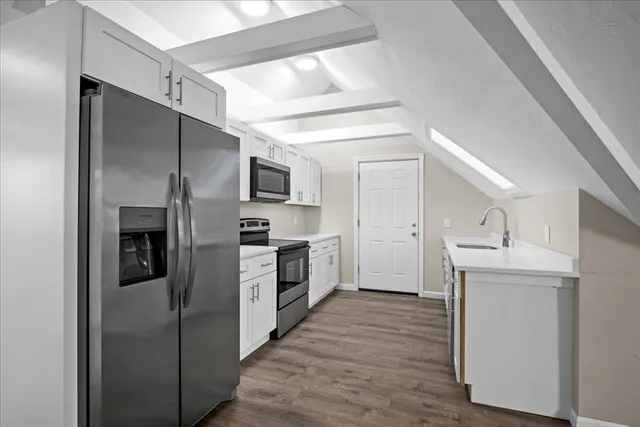 a kitchen with a refrigerator a sink and dishwasher