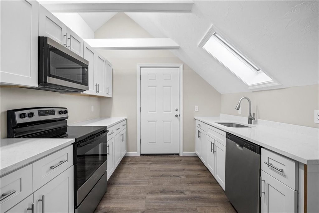 15 Clearview Avenue, Unit 3 Worcester, MA 01605 - Photo 4 of 24 a kitchen with stainless steel appliances granite countertop a sink and a stove top oven