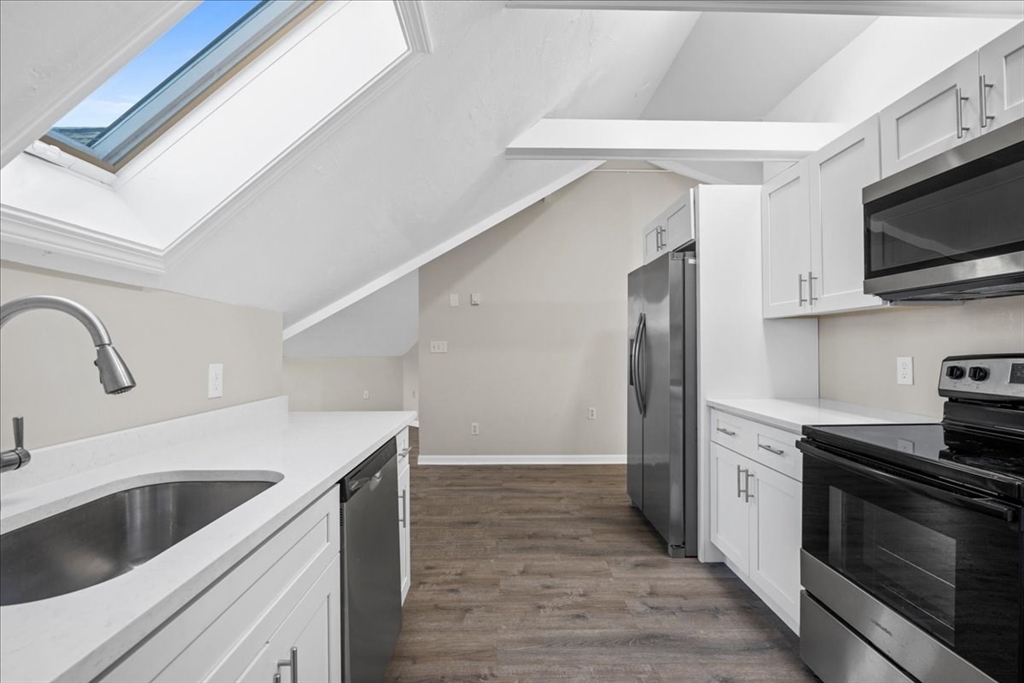 15 Clearview Avenue, Unit 3 Worcester, MA 01605 - Photo 6 of 24 a kitchen with stainless steel appliances granite countertop a sink and a stove top oven